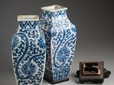 two blue and white vases sitting next to each other