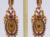 gold plated earrings with a picture of a woman in a dress