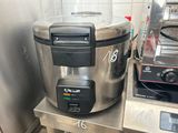 a silver and black blender sitting on a table in a kitchen