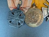 three medals and a medal on a blue table