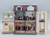 a doll house with a lot of dolls inside of it