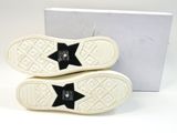 two pairs of white and black sneakers with black stars on them