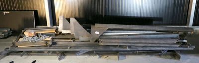 several pieces of metal are stacked on top of each other in a warehouse