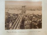 a black and white photo of a bridge over a city