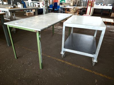 two tables that are sitting in the middle of a room