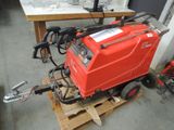 a red machine that is sitting on a pallet