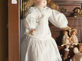 a doll in a display case with many dolls in it