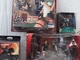 many different action figures in boxes on a white surface
