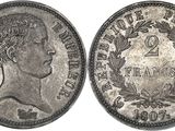a silver coin with the head of a man on it