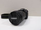 a camera that is sitting on a table next to a camera strap