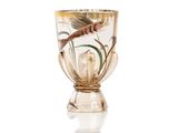 a glass cup with a fish in it on a white surface