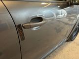 a close up of a car door handle with a sticker on it