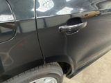 a close up of a car door handle with a hole in it