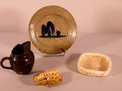 several pieces of pottery are displayed on a white surface