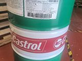 a green barrel with a label on it sitting on a red floor