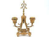 an image of a gold candle holder with two candles on it