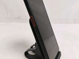 the phone is sitting on the stand on the table