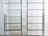 pair of chrome bookcases with glass shelves