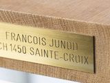 a brass plaque on a wooden bench that reads francisco junold ch 450 saint - croixx