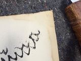 a piece of paper with writing on it next to a tennis racquet