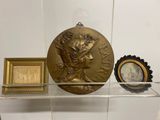 une étagère en verre sur laquelle sont posés une médaille d'or et une horloge
