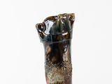 a small vase that is sitting on a white surface