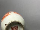 chinese white and orange vase with floral decoration on the outside