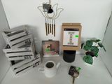 boxes of coffee, a cup of coffee, a clock, and a phone are on a table