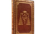 an old book with a coat of arms on the cover