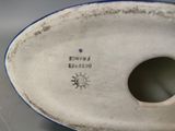 a close up of a vase with a hole in it