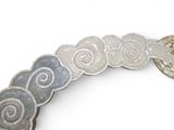 a close up of a bracelet with a flower design on it