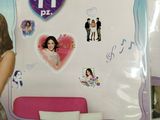 a girl standing in front of a whiteboard with pictures on it