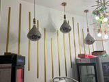 many lights hanging from the ceiling in this room