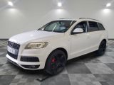 the white suv is parked on a checkered floor in the garage