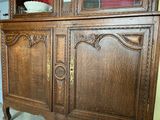 a wooden cabinet with a mirror on top of it