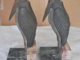 two statues of birds sitting on top of each other