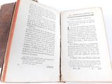 a book open on a table with a white background