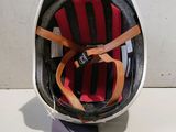 an image of a helmet with a red and black stripe on it