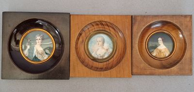 two framed pictures of a woman and a man in a wood frame
