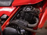 a close up of a red motorcycle with a black engine