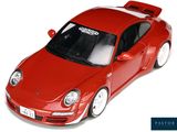 a red toy car that is sitting on a white surface