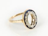 a close up of a gold ring with a blue and white stone