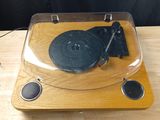 a record player sitting on top of a wooden table