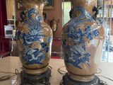 two vases sitting on a table in a room