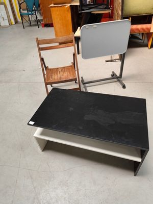 a black table and a white chair in a room