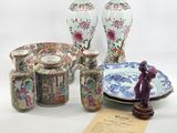 many different vases and plates on display on the table