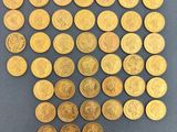 a pile of gold coins sitting on top of a blue surface