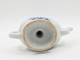 a blue and white vase on a white surface