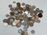 a pile of coins sitting on a table with a white background