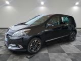 the black car is parked in the garage on a checkered floor
